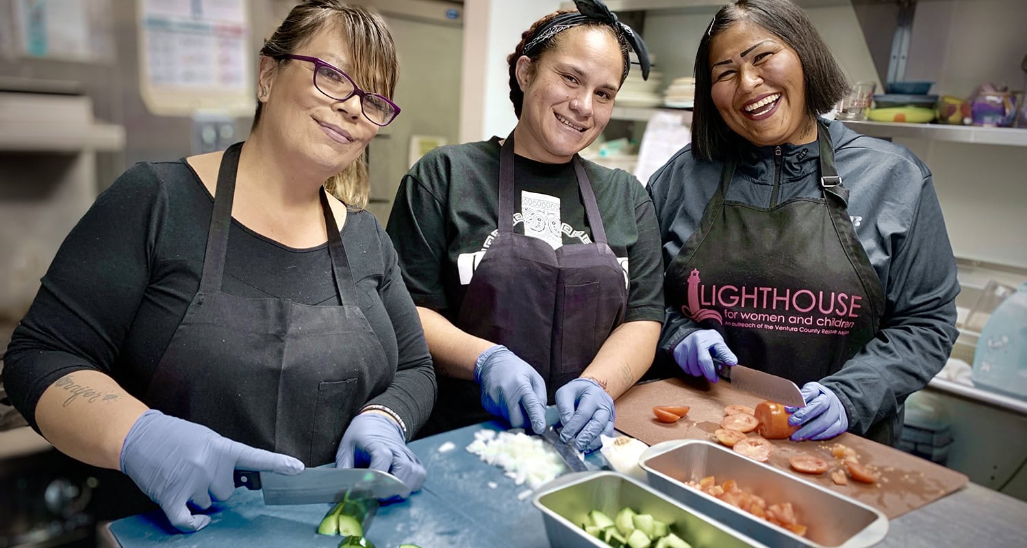 Vegetarian cooking class at Rescue Mission Alliance Ventura County with smiling women chefs in kitchen.