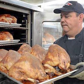 Rescue Mission Cook Putting Turkeys in the Oven