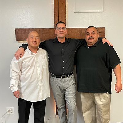 Three Men in Front of a Cross