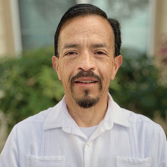 Rescue Mission Alliance Ventura County volunteer smiling outdoors in natural light.